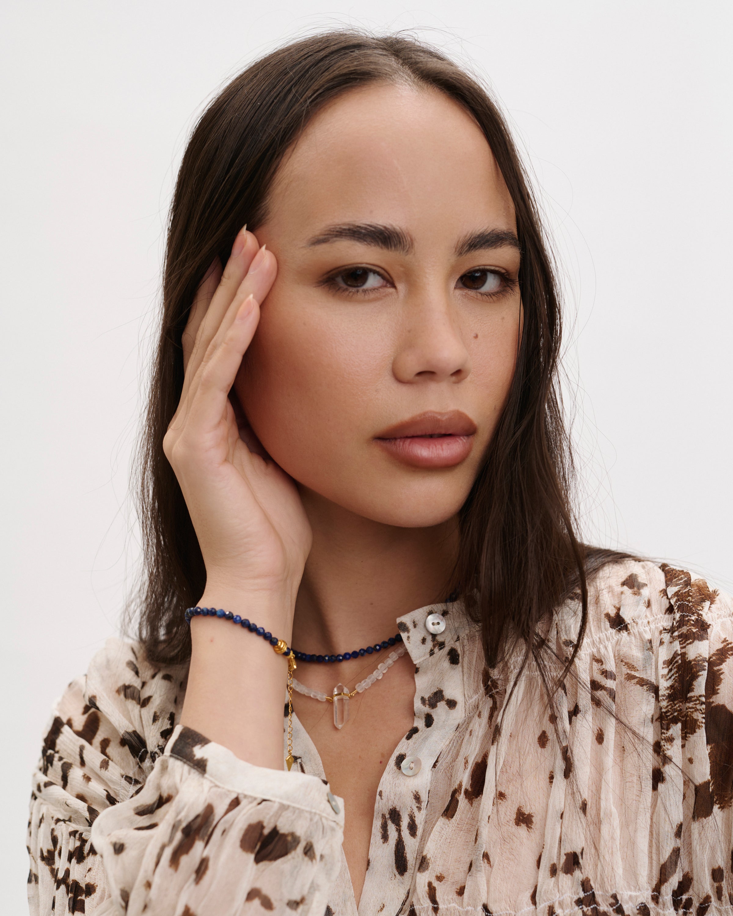 ETERNA NOCTA Lapis Lazuli necklace and bracelet / ENCARA LUNOR Moonstone necklace with raw polished quartz point pendant, gold 8 cm extension chain and clasp, arrowhead-shaped fantasy signature, and 4 mm faceted lazurite / moonstone bead strand.