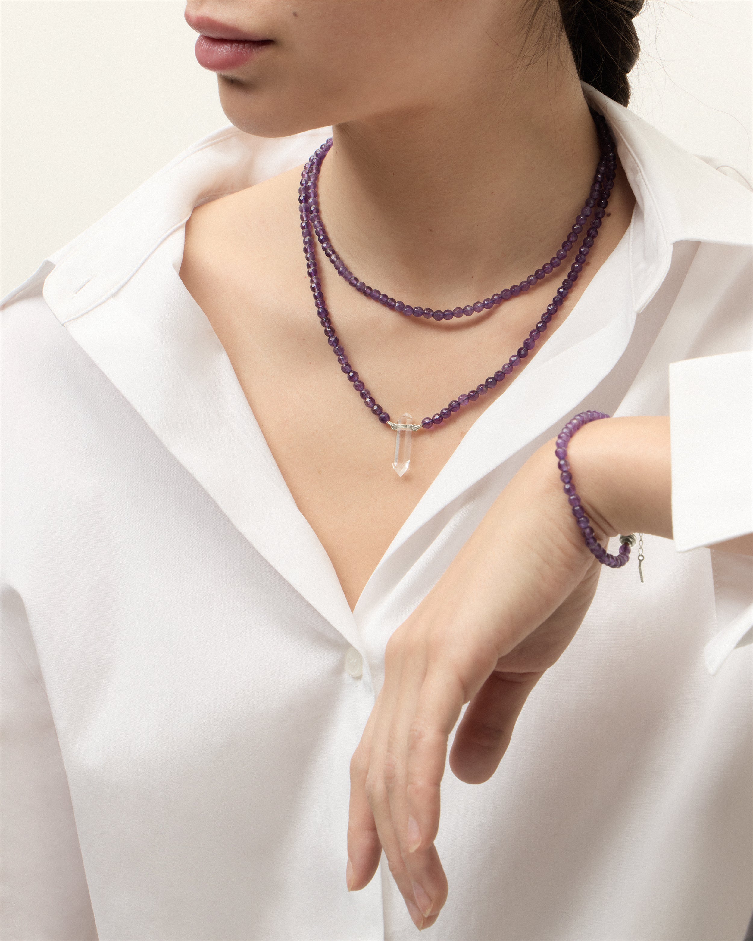 ENCARA / ETERNA VÉLA Amethyst necklaces and bracelet with polished silver spiral bead, extension chain and clasp, arrowhead-shaped fantasy signature, and 4 mm faceted amethyst bead strand and raw polished quartz point pendant.