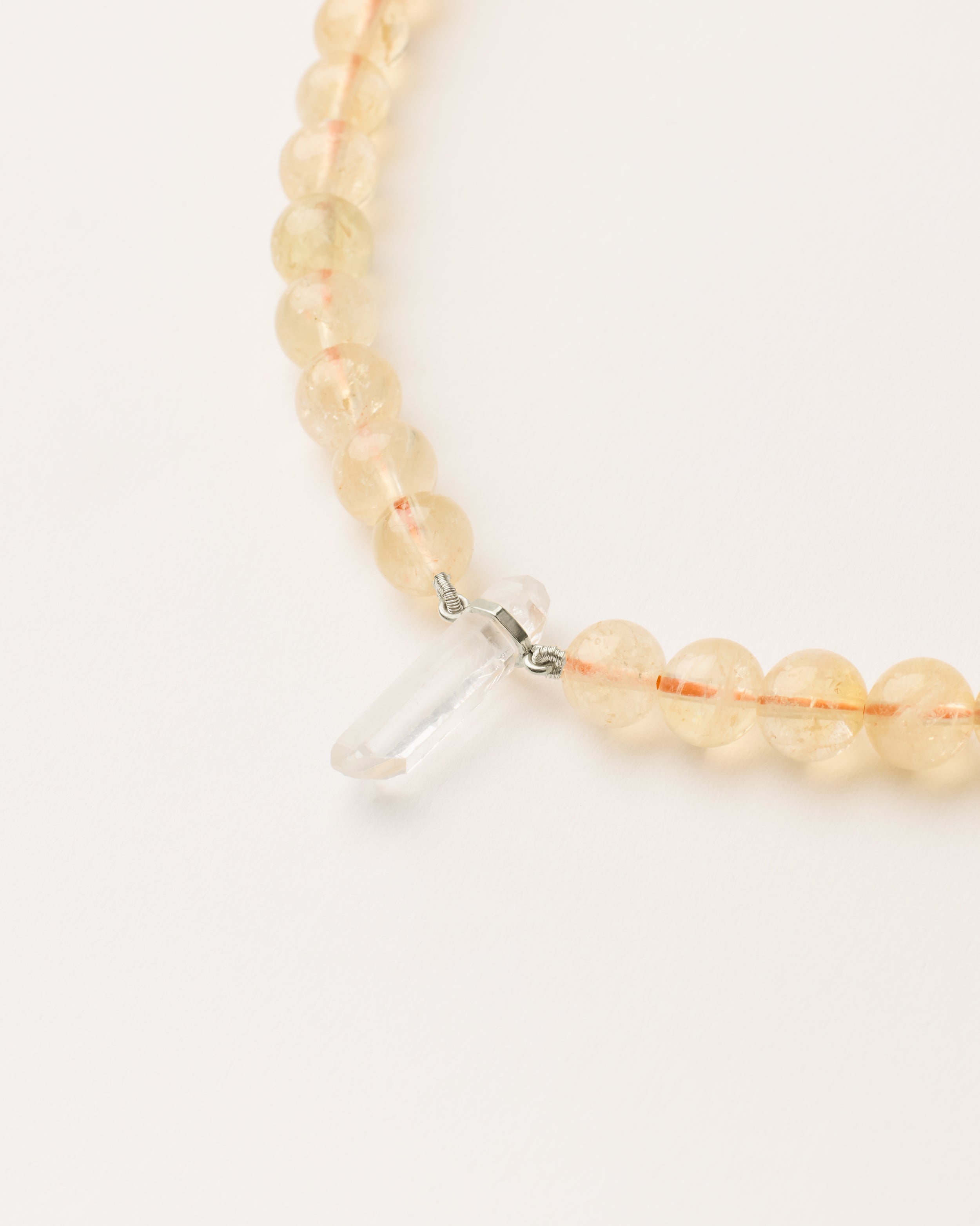 ENCARA SOLIS Citrine necklace with raw polished quartz point pendant, silver 8 cm extension chain and clasp, arrowhead-shaped fantasy signature, and 8 mm faceted citrine bead strand.