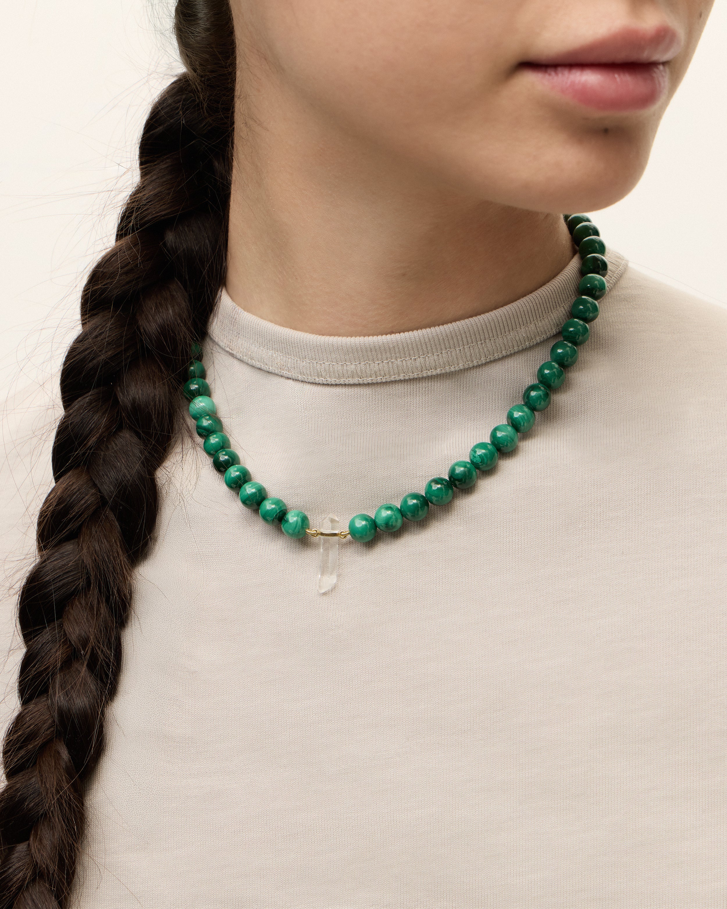 ENCARA VERDAN Malachite necklace with raw polished quartz point pendant, gold 8 cm extension chain and clasp, arrowhead-shaped fantasy signature, and 8 mm faceted malachite bead strand.