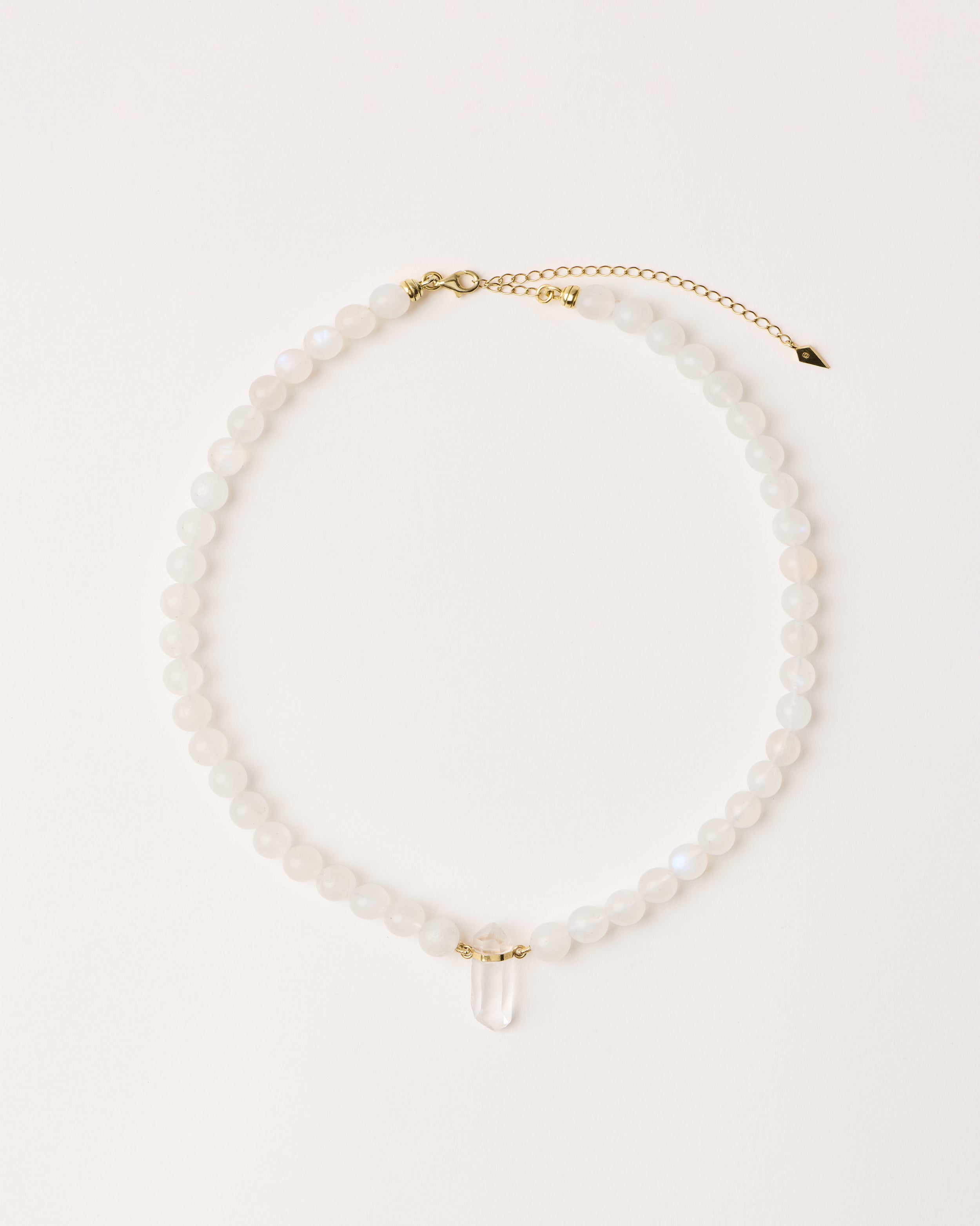ENCARA LUNOR Moonstone necklace with raw polished quartz point pendant, gold 8 cm extension chain and clasp, arrowhead-shaped fantasy signature, and 8 mm faceted moonstone bead strand.