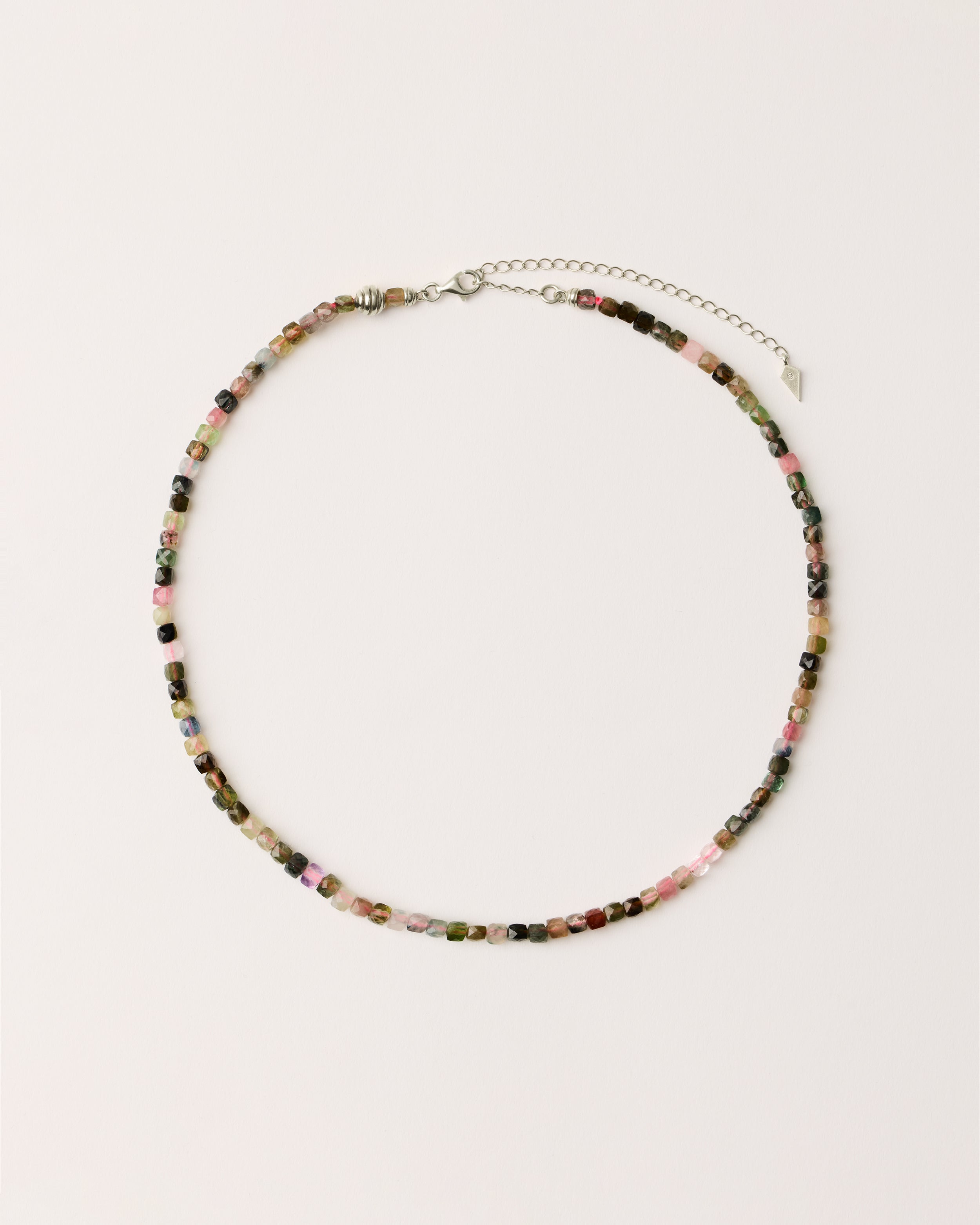 ETERNA AURIL Tourmaline necklace with polished silver spiral bead, 8 cm extension chain and clasp, arrowhead-shaped fantasy signature, and 4 mm faceted tourmaline bead strand.