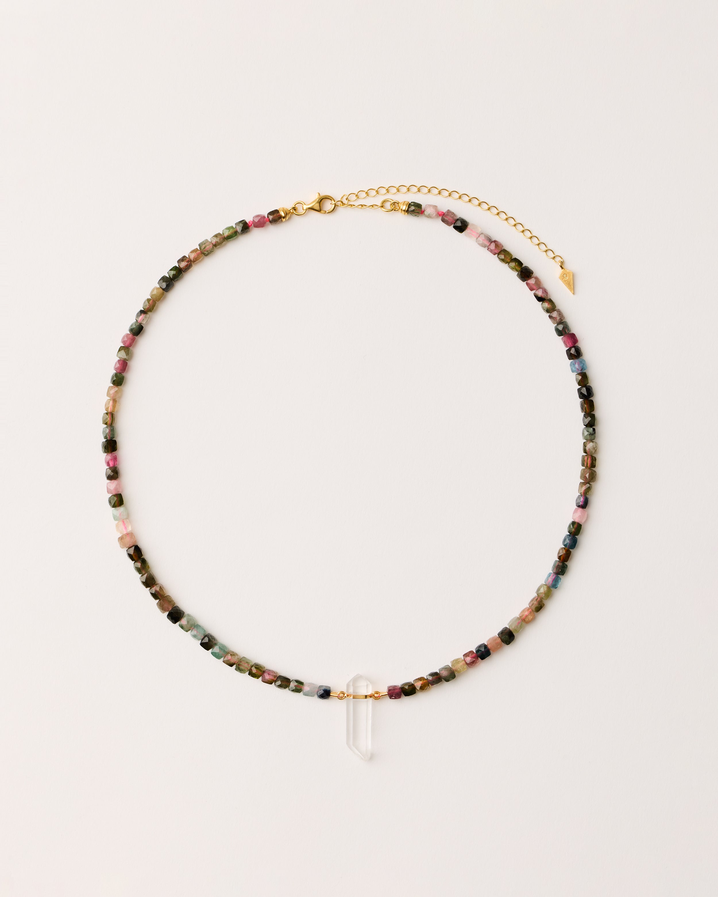 ENCARA AURIL Tourmaline necklace with raw polished quartz point pendant, gold-plated silver 8 cm extension chain and clasp, arrowhead-shaped fantasy signature, and 4 mm faceted tourmaline bead strand.
