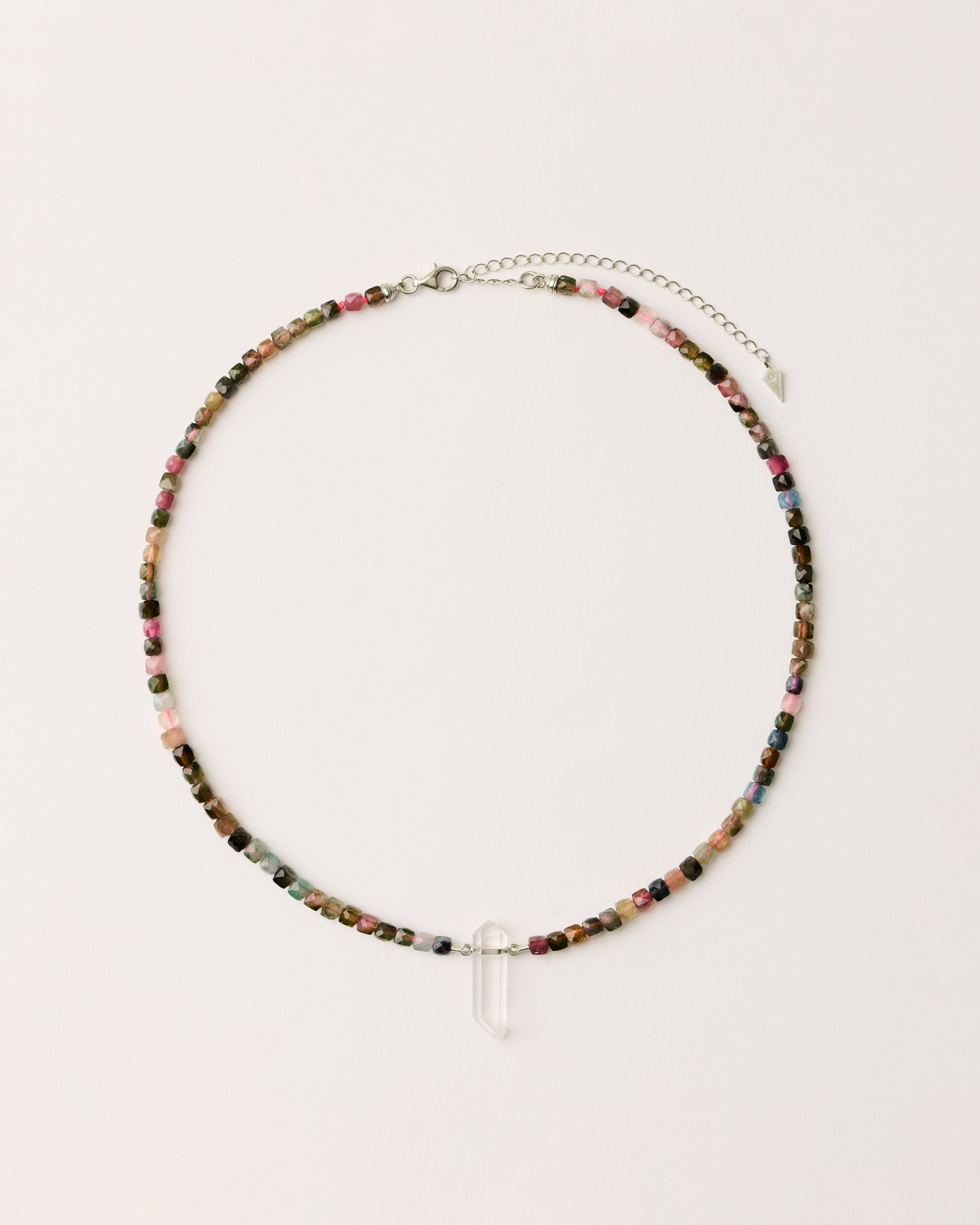 ENCARA AURIL Tourmaline necklace with raw polished quartz point pendant, silver 8 cm extension chain and clasp, arrowhead-shaped fantasy signature, and 4 mm faceted tourmaline bead strand.
