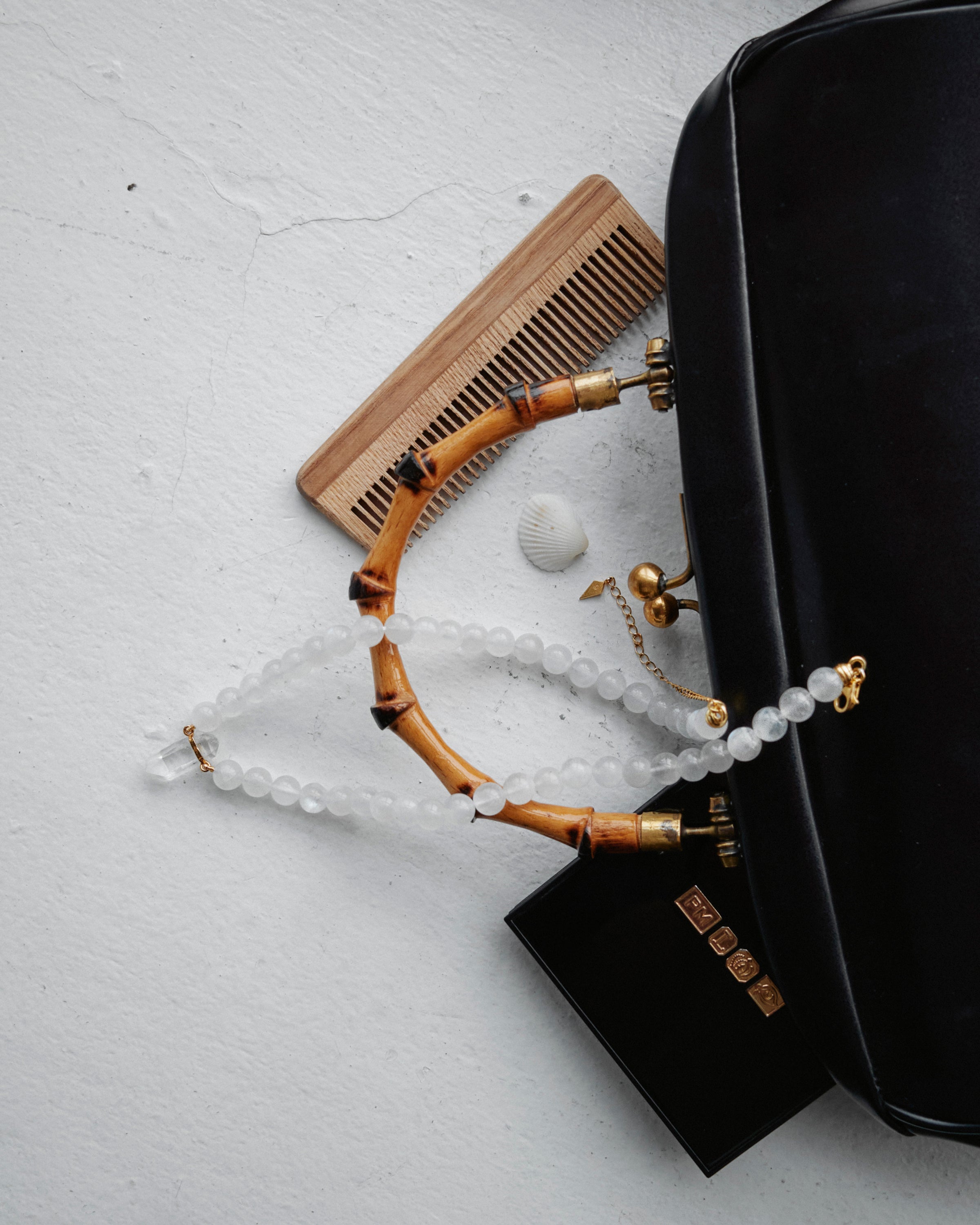 ENCARA LUNOR Moonstone necklace with raw polished quartz point pendant, gold 8 cm extension chain and clasp, arrowhead-shaped fantasy signature, and 8 mm faceted moonstone bead strand.