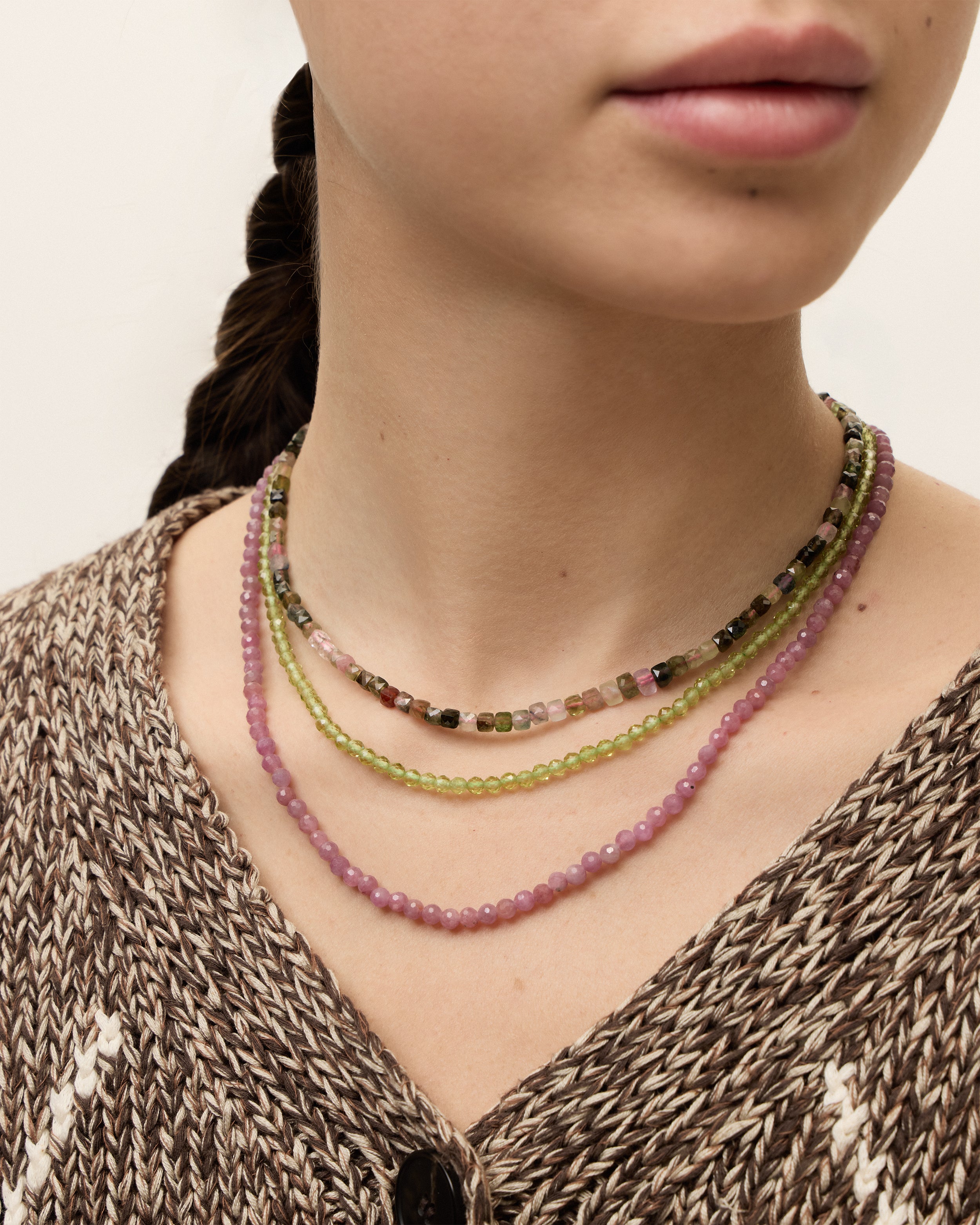 ETERNA AURIL Tourmaline / ETERNA OLMAR Peridot / ETERNA CARMES Ruby necklace with gold 8 cm extension chain and clasp, arrowhead-shaped fantasy signature, and 4 mm faceted tourmaline / chrysolite / ruby bead strand.