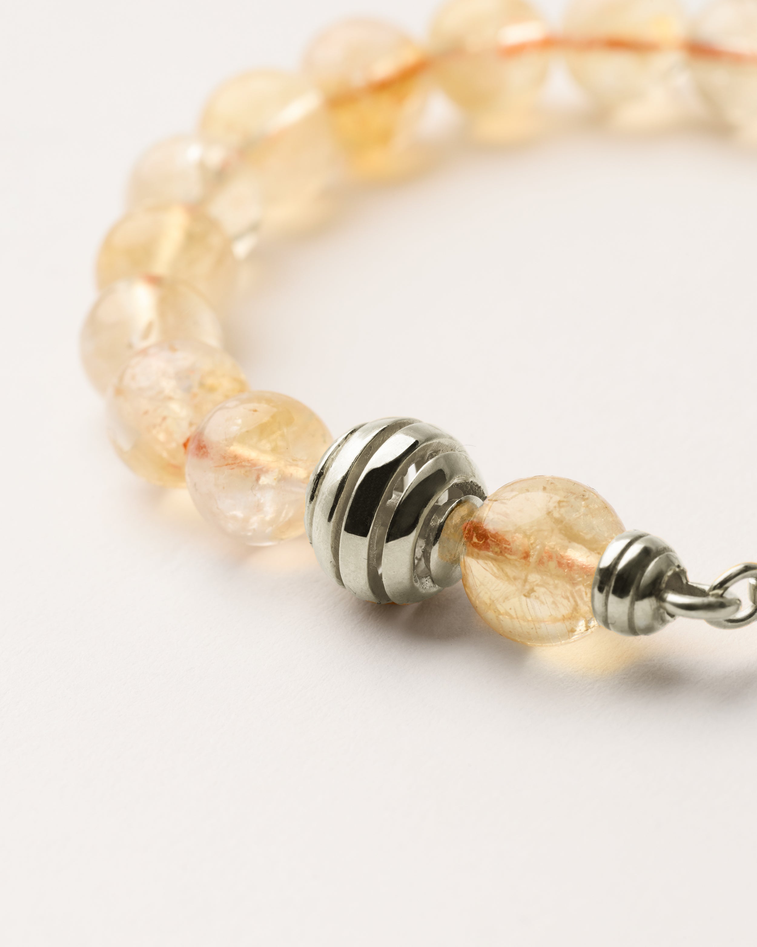 ETERNA SOLIS Citrine bracelet with polished silver spiral bead, 4 cm extension chain and clasp, arrowhead-shaped fantasy signature, and 8 mm faceted citrine bead strand.