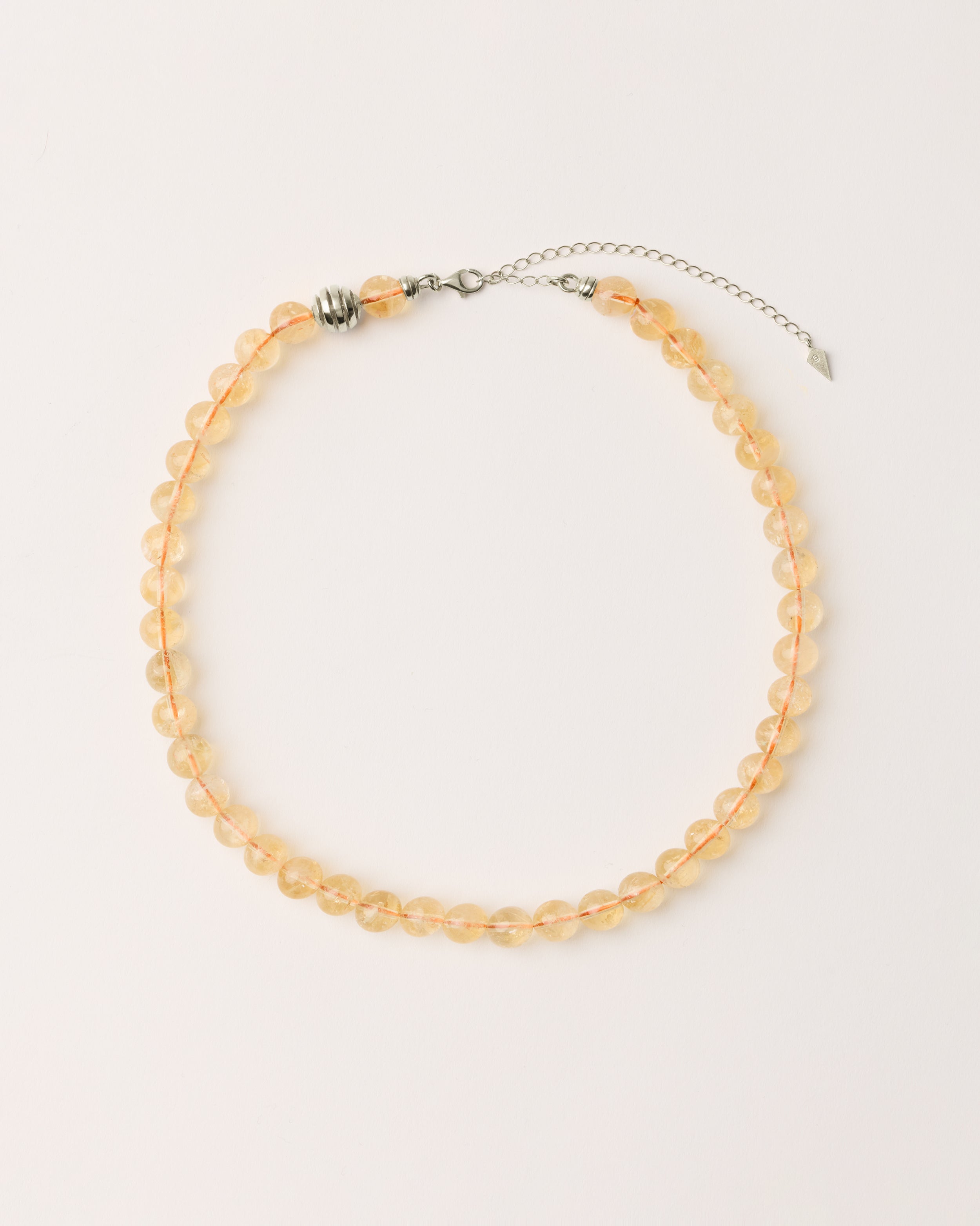 ETERNA SOLIS Citrine necklace with polished silver spiral bead, 8 cm extension chain and clasp, arrowhead-shaped fantasy signature, and 8 mm faceted citrine bead strand.