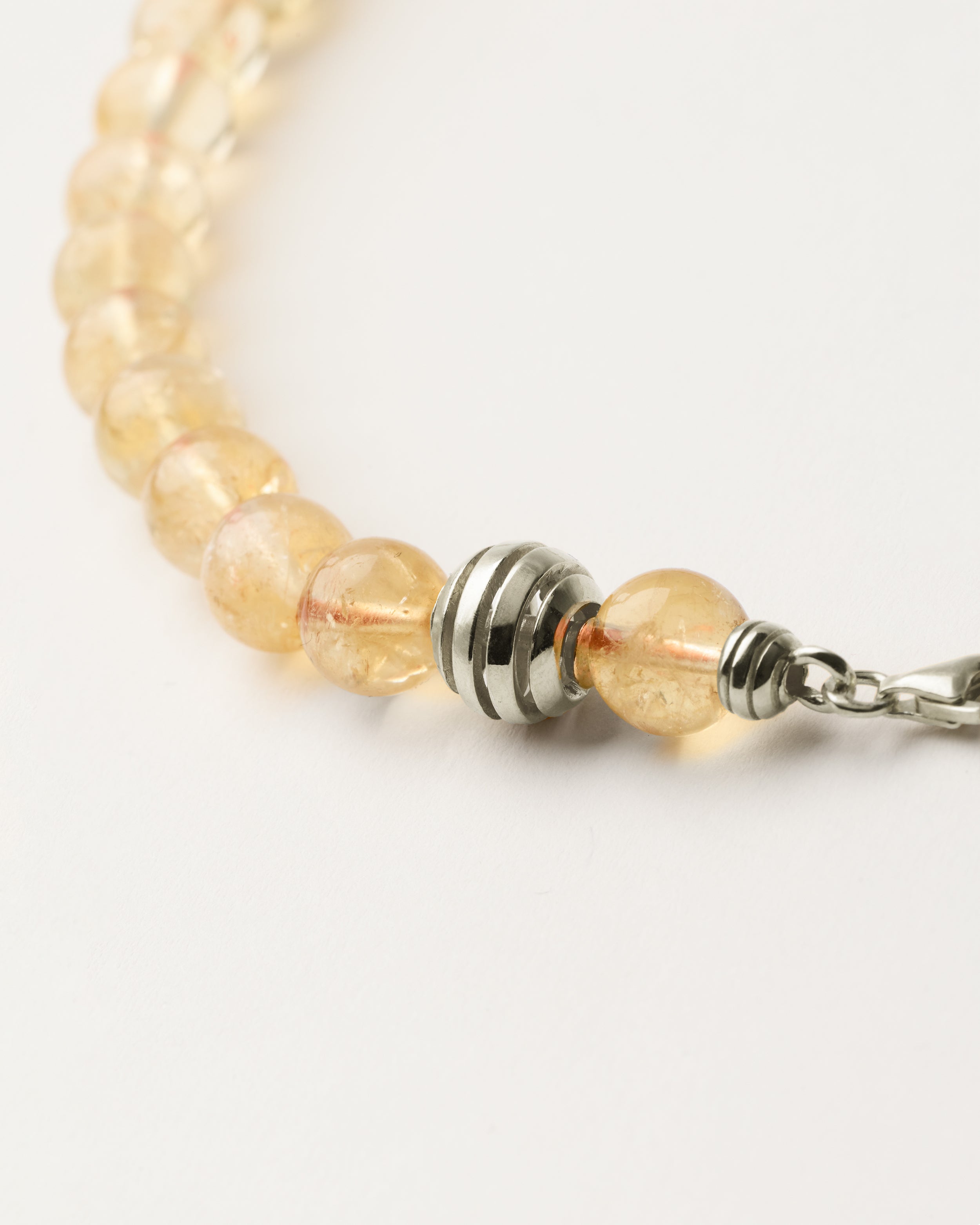 ETERNA SOLIS Citrine necklace with polished silver spiral bead, 8 cm extension chain and clasp, arrowhead-shaped fantasy signature, and 8 mm faceted citrine bead strand.
