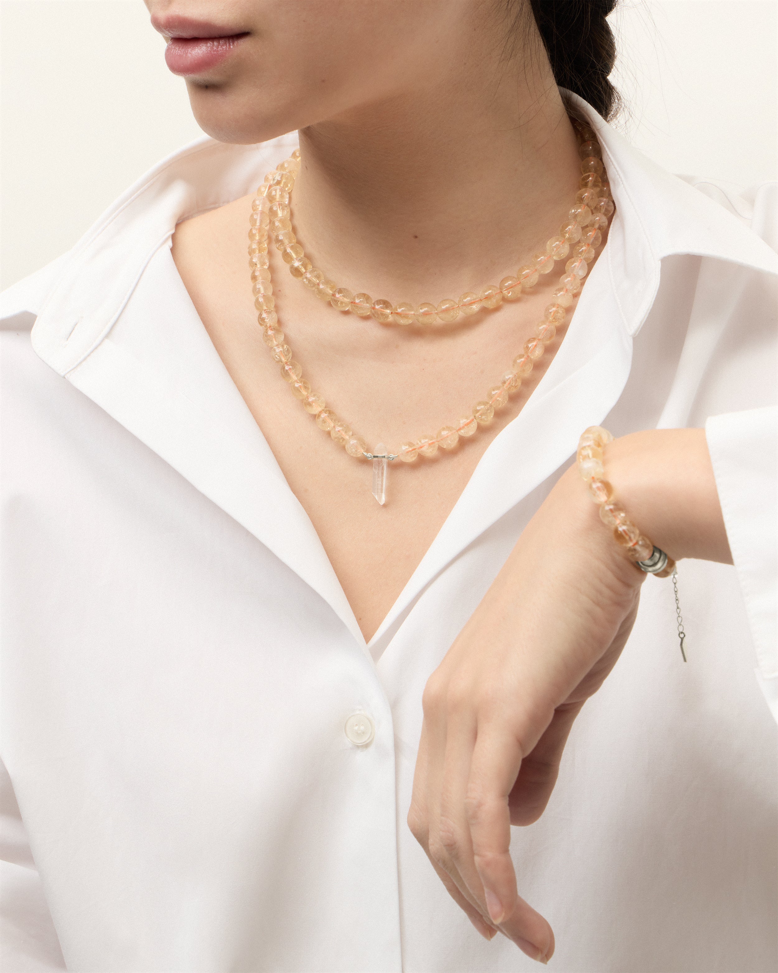 ENCARA / ETERNA SOLIS Citrine necklaces and bracelet with polished silver spiral bead, extension chain and clasp, arrowhead-shaped fantasy signature, and 8 mm faceted citrine bead strand and raw polished quartz point pendant.