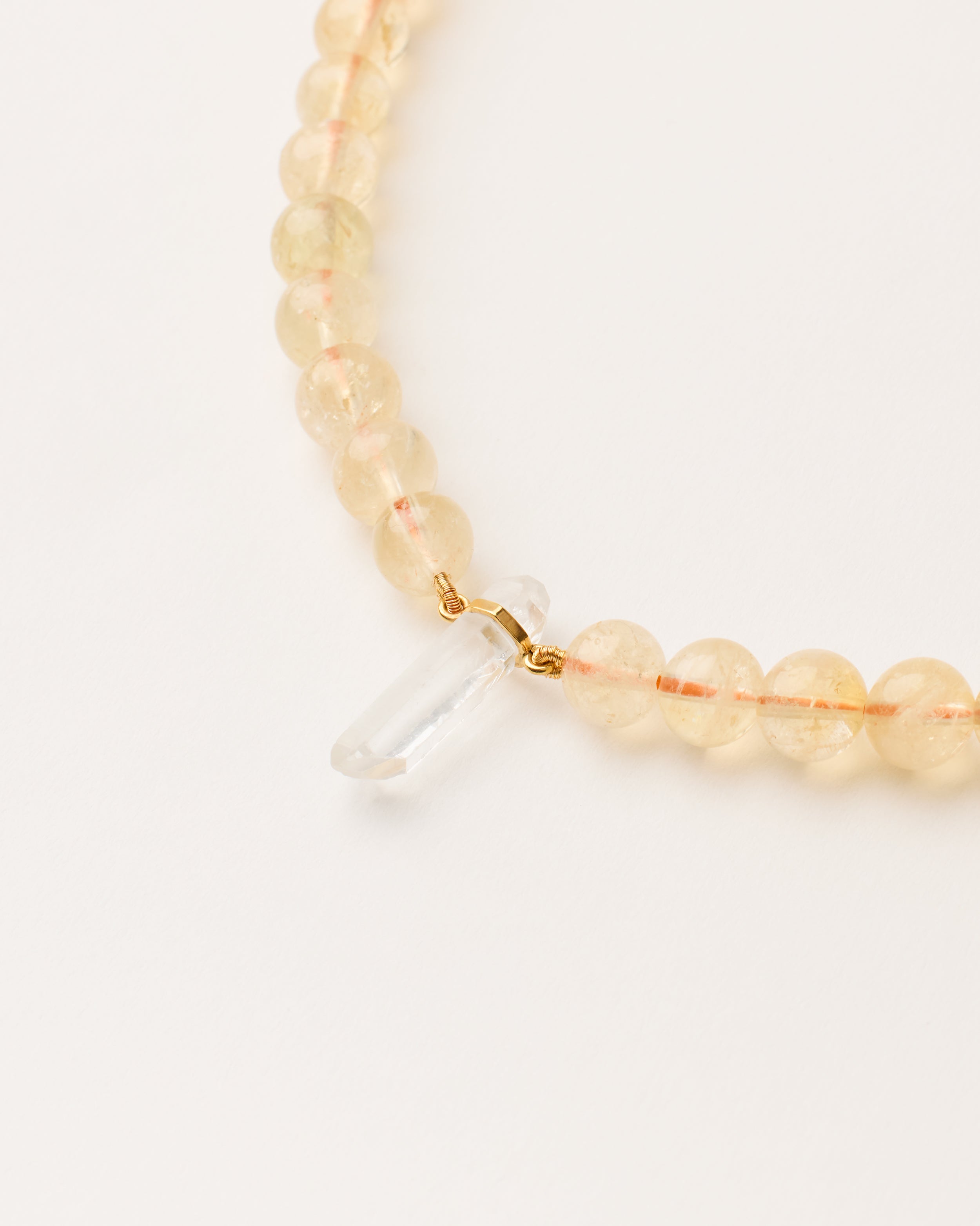 ENCARA SOLIS Citrine necklace with raw polished quartz point pendant, gold-plated silver 8 cm extension chain and clasp, arrowhead-shaped fantasy signature, and 8 mm faceted citrine bead strand.