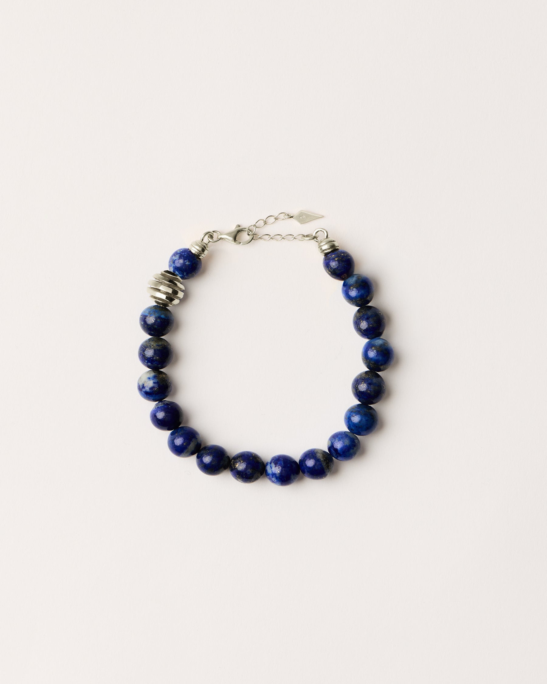 ETERNA NOCTA Lapis Lazuli necklace with polished silver spiral bead, 8 cm extension chain and clasp, arrowhead-shaped fantasy signature, and 8 mm faceted lazurite bead strand.