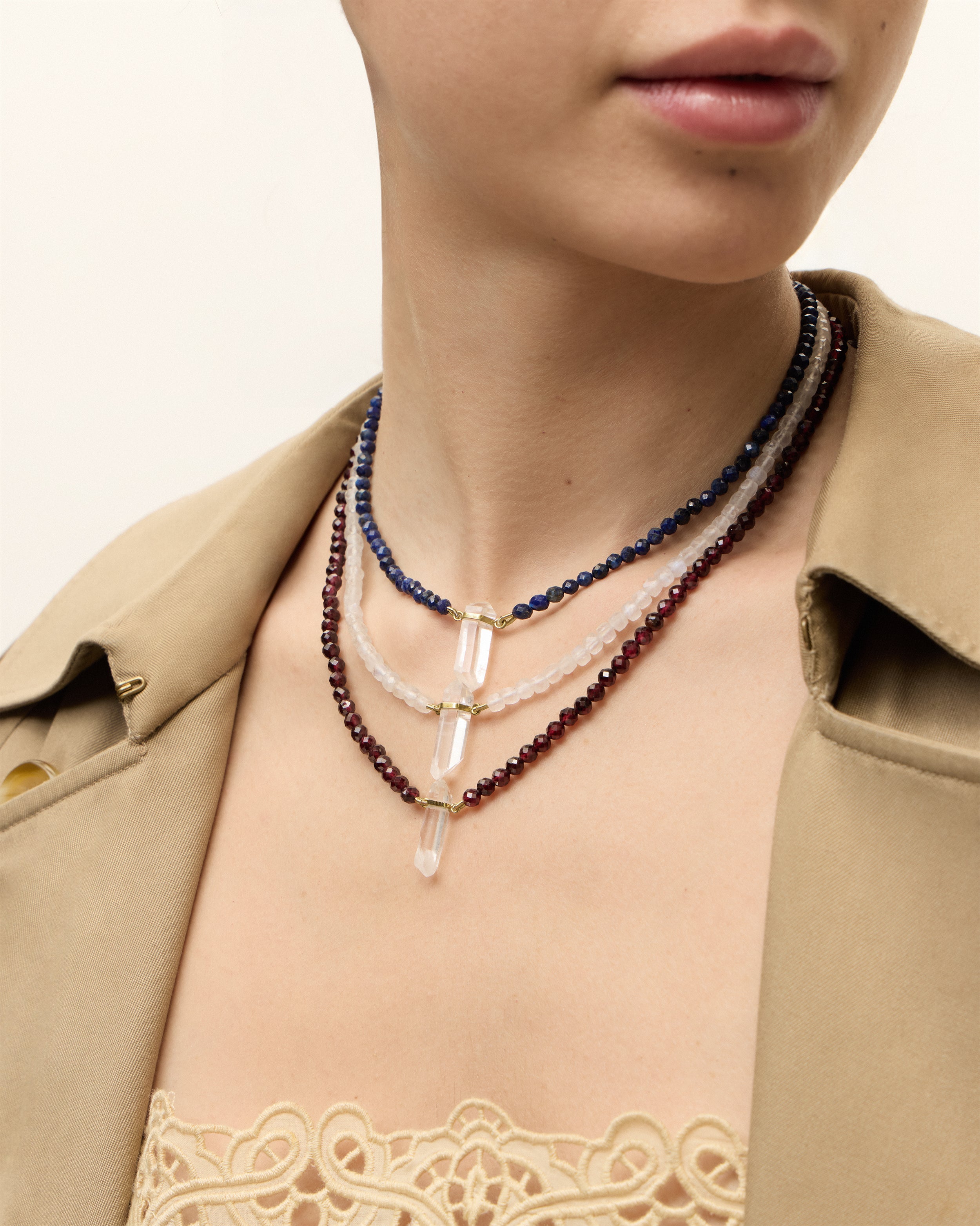 ENCARA NOCTA Lapis Lazuli / ENCARA LUNOR Moonstone / ENCARA INFERA Garnet necklace with raw polished quartz point pendant, gold 8 cm extension chain and clasp, arrowhead-shaped fantasy signature, and 4 mm faceted lazurite, moonstone, garnet, bead strand.