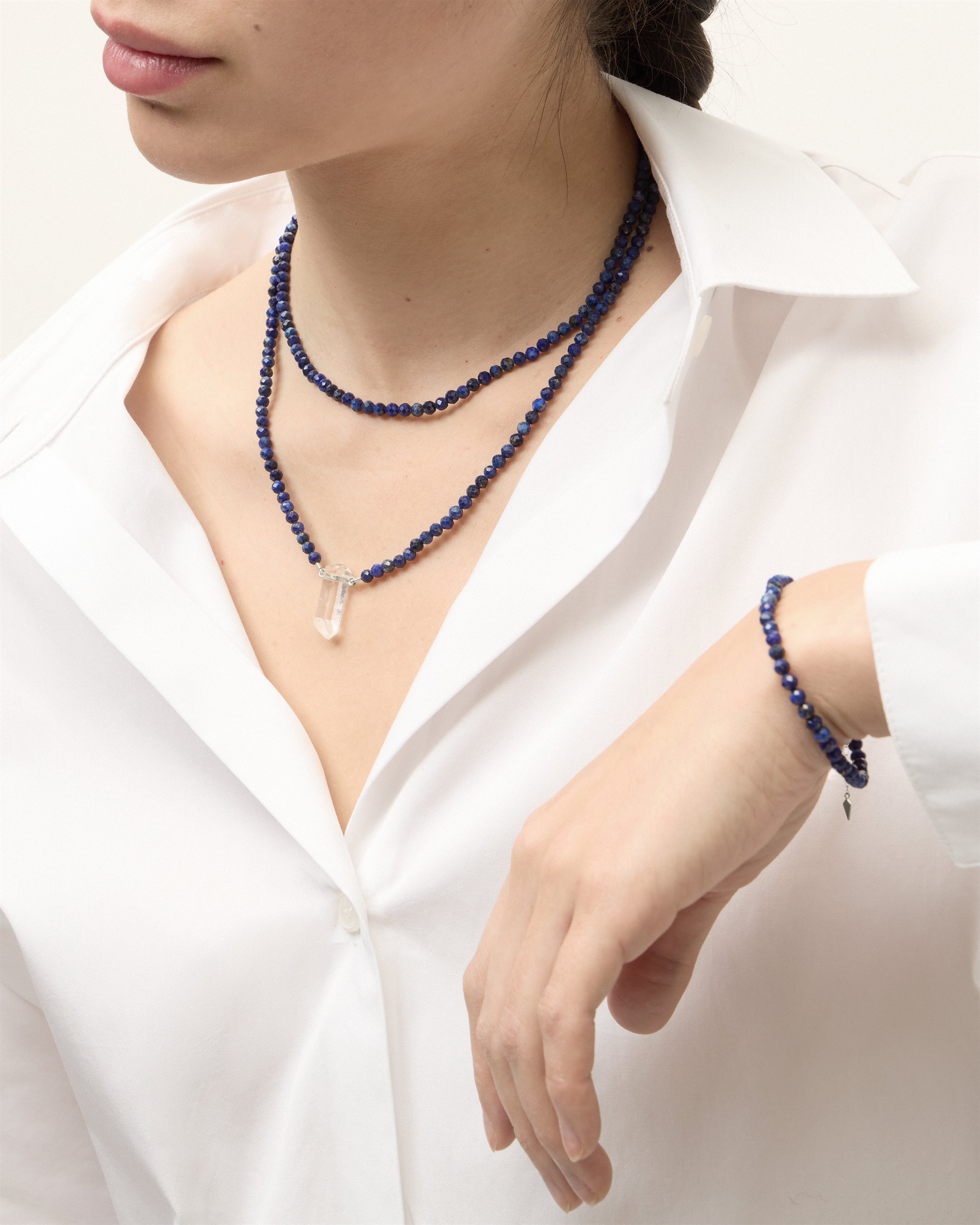 ENCARA / ETERNA NOCTA Lapis Lazuli necklaces and bracelet with polished silver spiral bead, extension chain and clasp, arrowhead-shaped fantasy signature, and 4 mm faceted lazurite bead strand and raw polished quartz point pendant.