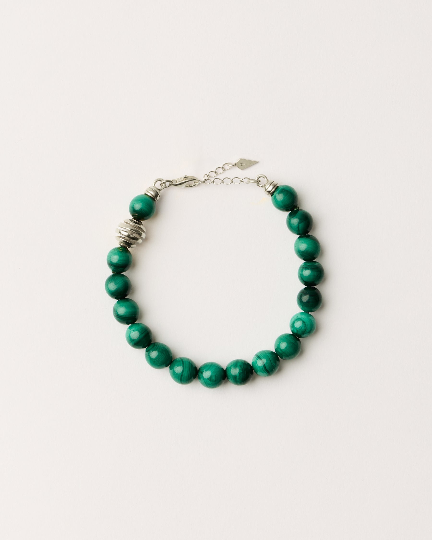 ETERNA VERDAN Malachite bracelet with polished silver spiral bead, 4 cm extension chain and clasp, arrowhead-shaped fantasy signature, and 8 mm faceted malachite bead strand.