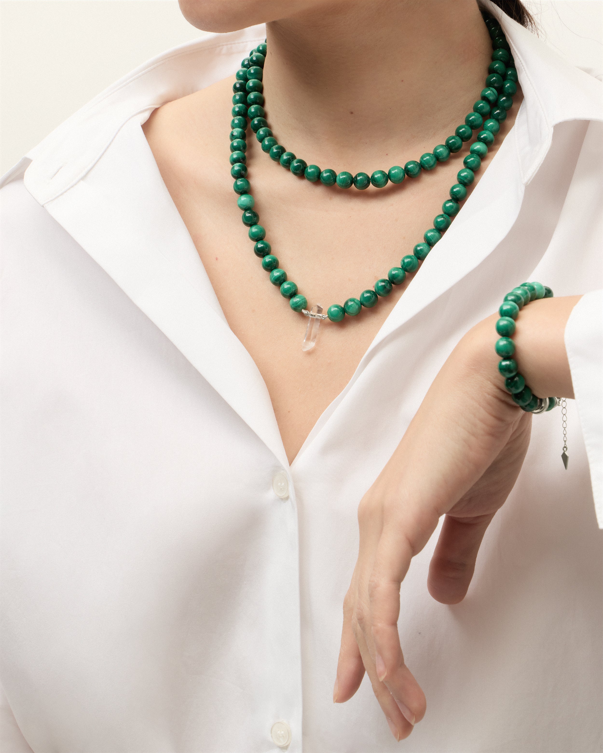 ENCARA / ETERNA VERDAN Malachite necklaces and bracelet with polished silver spiral bead, extension chain and clasp, arrowhead-shaped fantasy signature, and 8 mm faceted malachite bead strand and raw polished quartz point pendant.