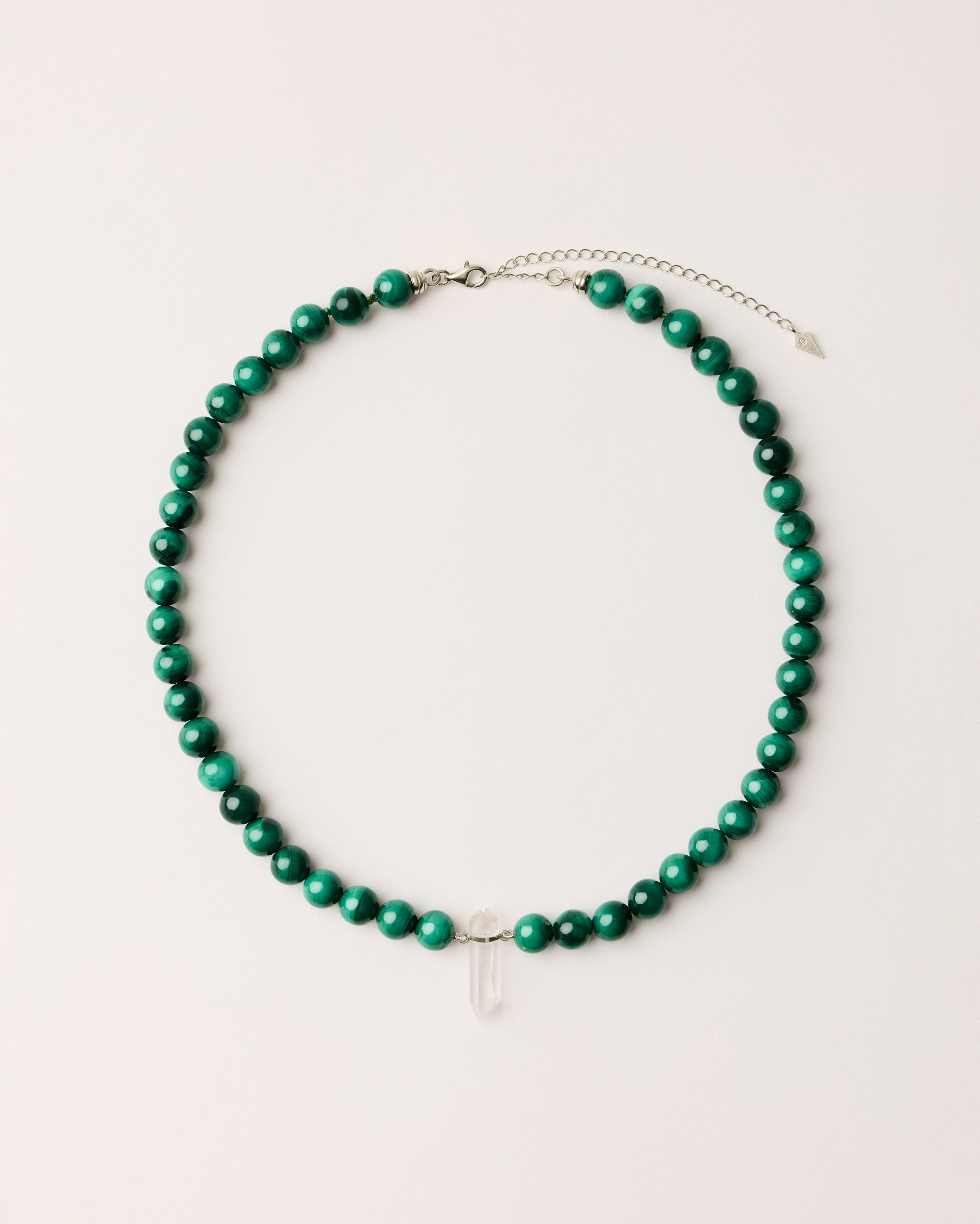 ENCARA VERDAN Malachite necklace with raw polished quartz point pendant, silver 8 cm extension chain and clasp, arrowhead-shaped fantasy signature, and 8 mm faceted malachite bead strand.