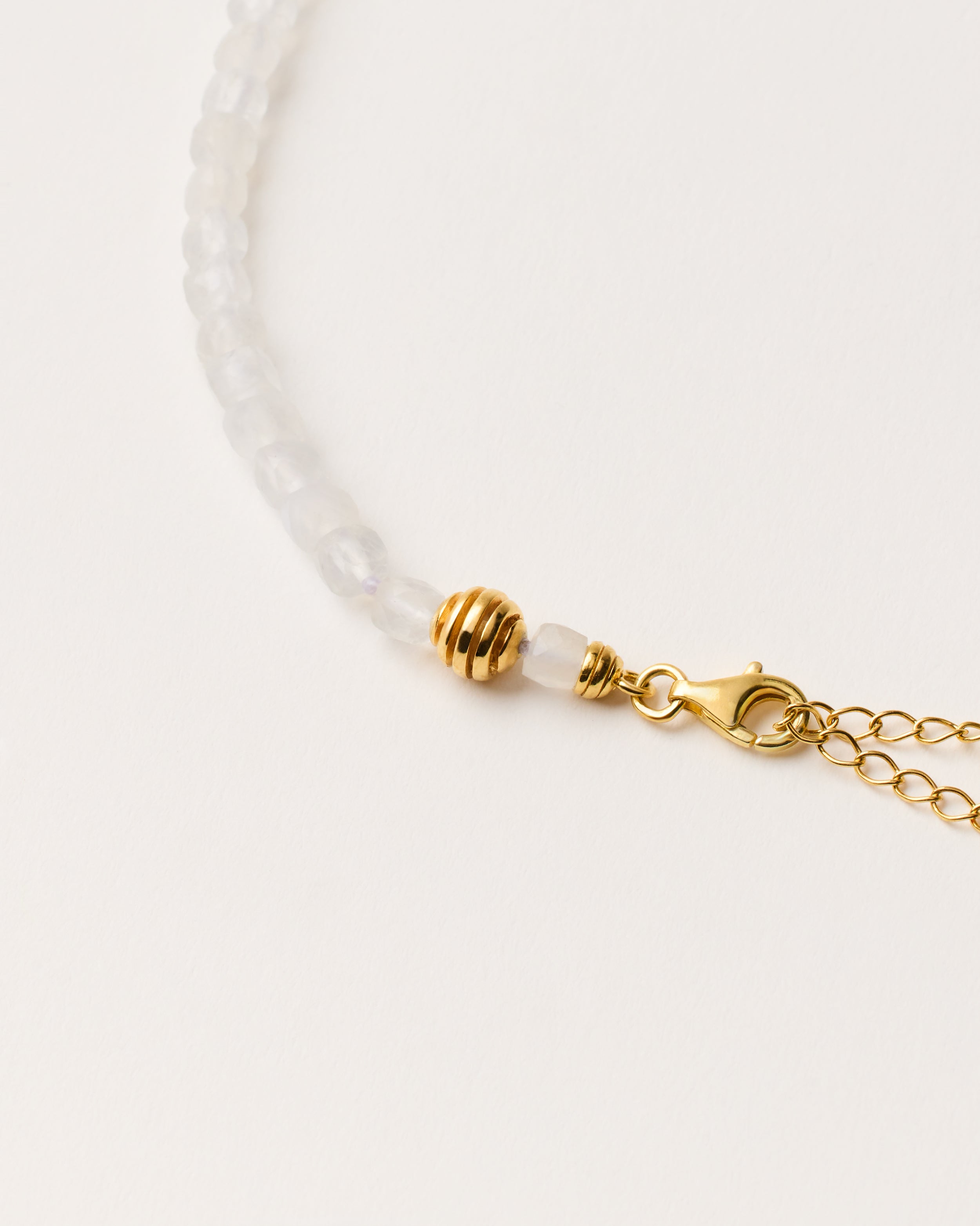 ETERNA LUNOR Moonstone necklace with polished gold-plated silver spiral bead, 8 cm extension chain and clasp, arrowhead-shaped fantasy signature, and 4 mm faceted moonstone bead strand.