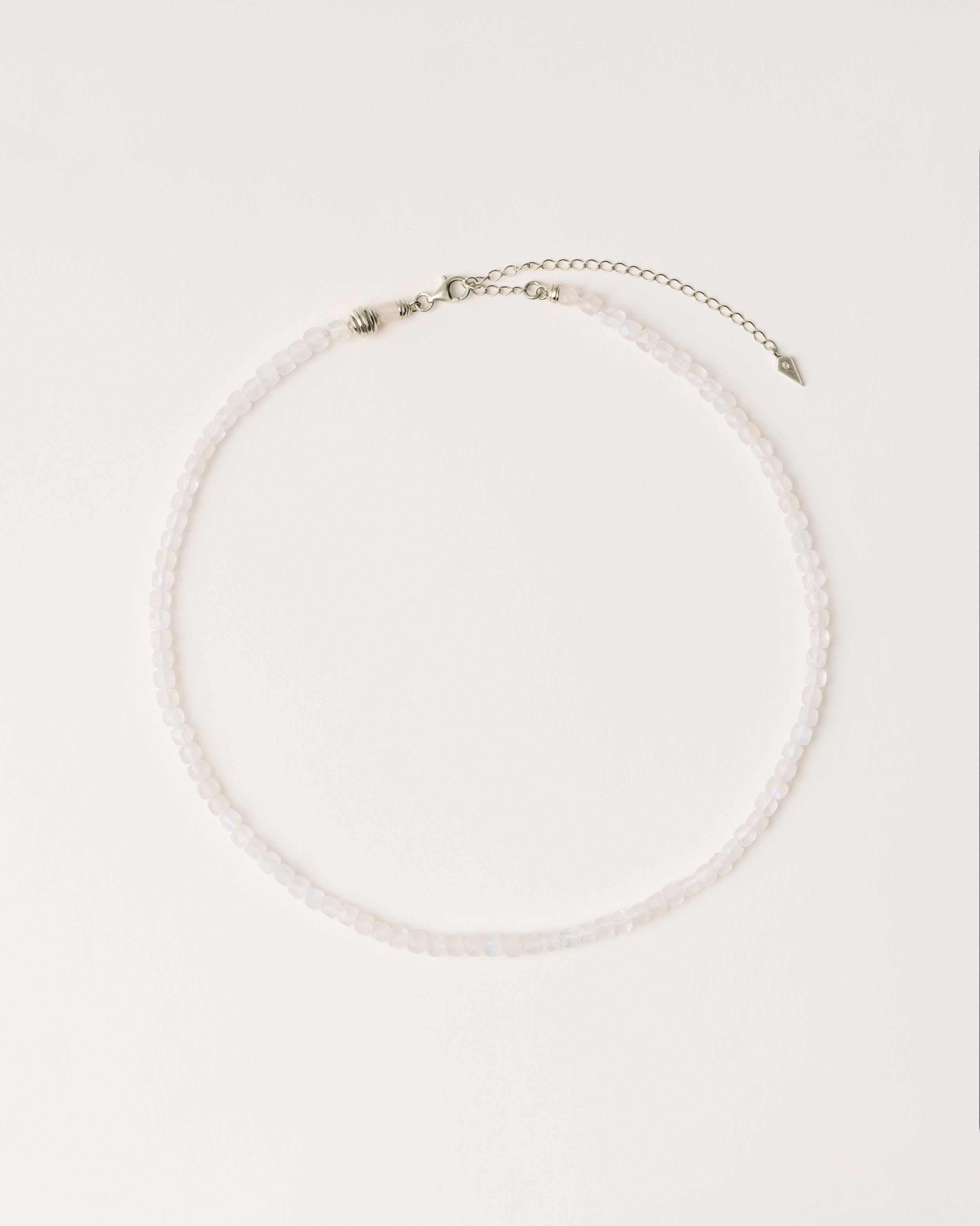 ETERNA LUNOR Moonstone necklace with polished silver spiral bead, 8 cm extension chain and clasp, arrowhead-shaped fantasy signature, and 4 mm faceted moonstone bead strand.
