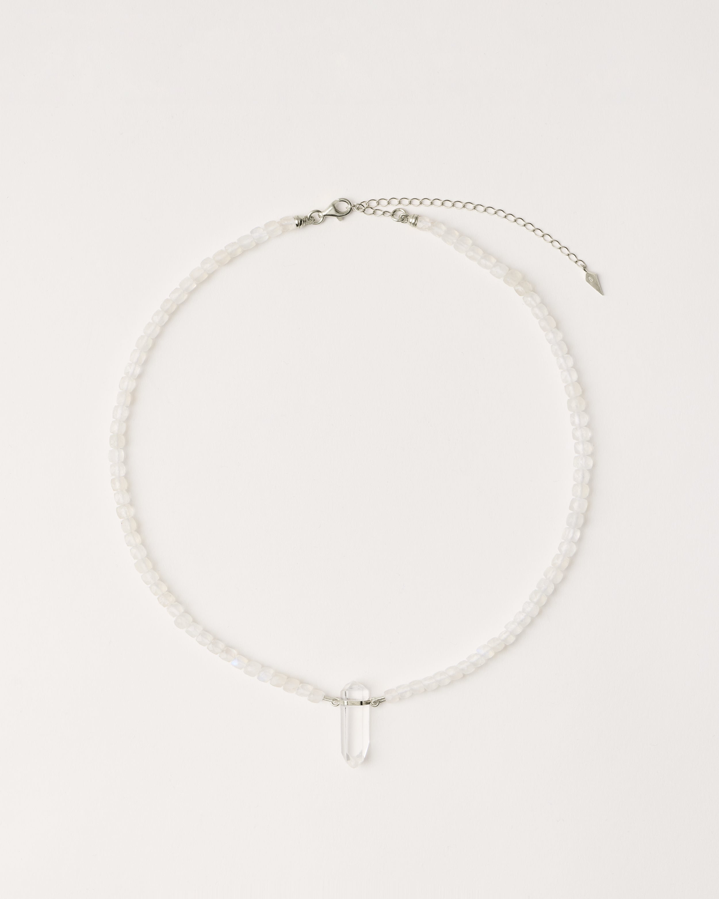 ENCARA LUNOR Moonstone necklace with raw polished quartz point pendant, silver 8 cm extension chain and clasp, arrowhead-shaped fantasy signature, and 4 mm faceted moonstone bead strand.